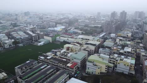 overcast cityscape with dense buildings, aerial view of an urban area on a cloudy day