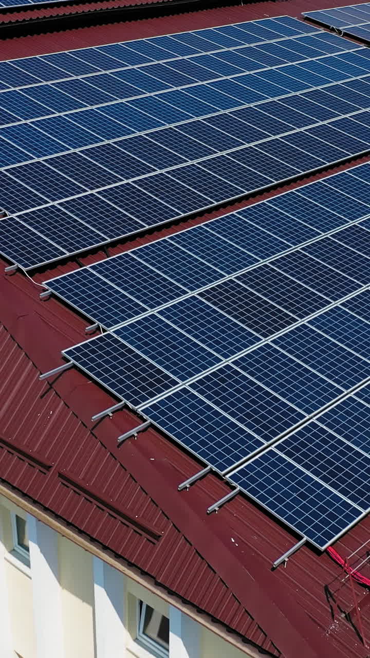 Aerial view. Top view on blue solar pannels. Green energy. Pannels on the roof. Vertical video