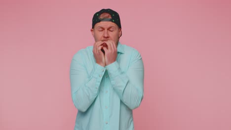 young scared man biting nails feeling worried nervous about serious troubles stress and anxiety
