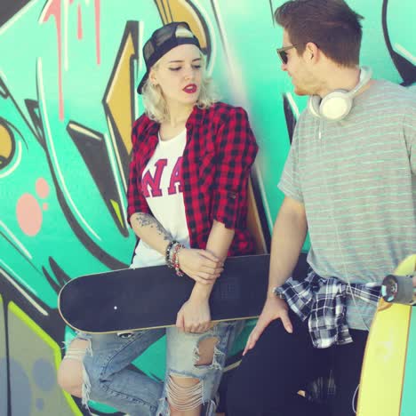 Trendy-modern-urban-couple-chatting-at-skate-park