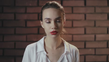 Portrait-scared-woman-with-opened-mouth-from-shock-on-brick-wall-background