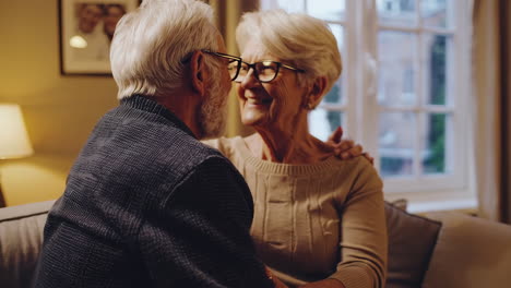 affectionate elderly couple in living room