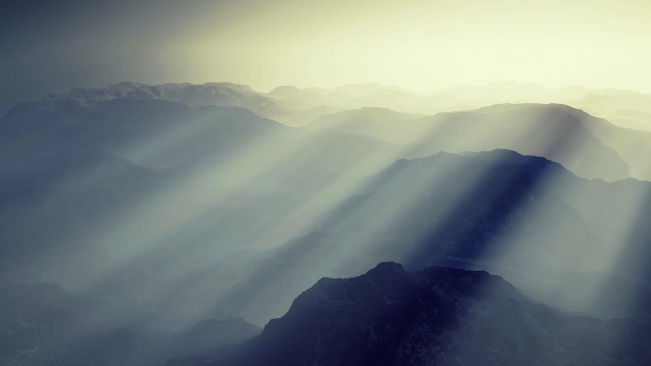 Majestic mountain range bathed in soft rays of sunlight at dawn