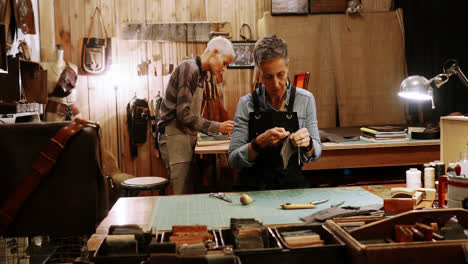 craftswoman stitching a piece of leather