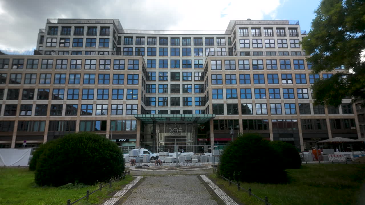 Front view of a modern office building with a glass facade in Berlin's business district