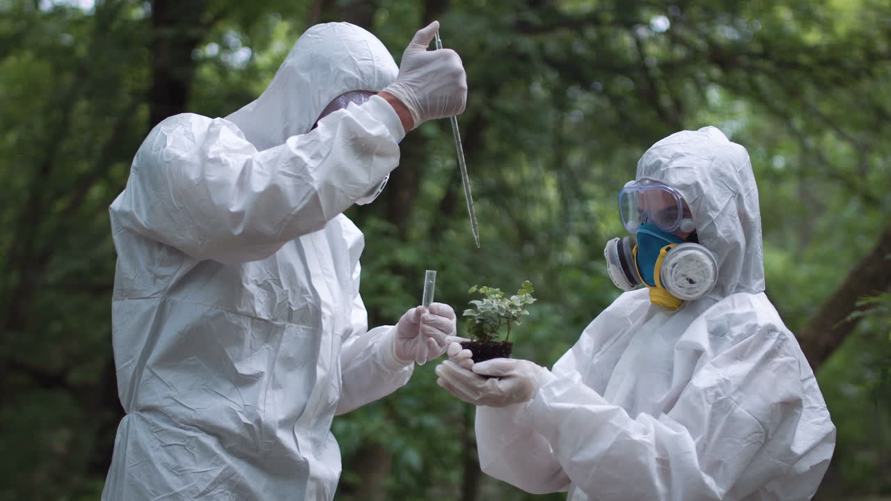 Scientists conducting plant research in protective gear