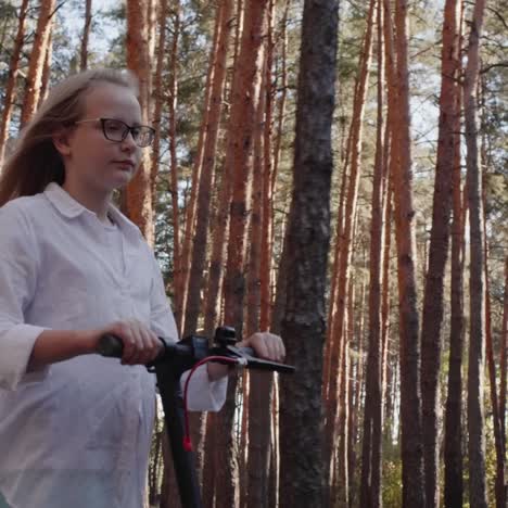 A-child-rides-a-scooter-amongst-tall-trees-1