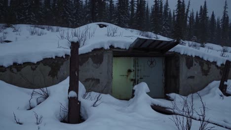 abandoned snow-covered bunker in the mountains