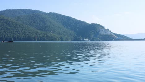 a boat travels across a calm, scenic lake