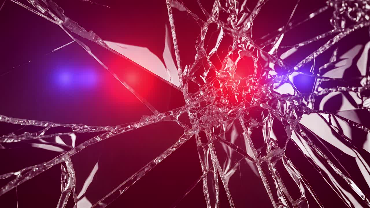 Ambulance and police lights flash behind shattered glass. Accident, crime scene, or emergency concept with red and blue lights