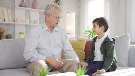 Father-and-son-chatting-and-hugging-at-home.