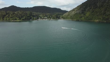 aerial view of a lake with a boat surrounded by mountains