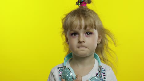 amused child laughing out loud with tears, feeling carefree joyful after hearing funny, silly joke