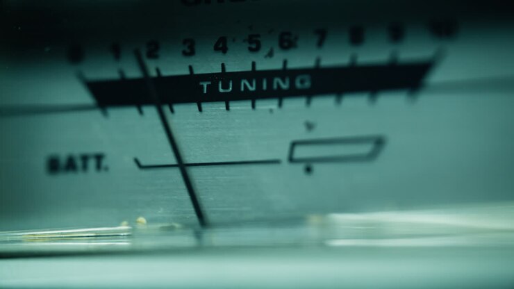 Closeup radio tuner scale with numeric frequency indicators and word tuning