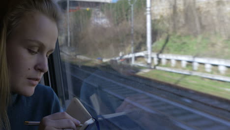 woman making sketches during train ride