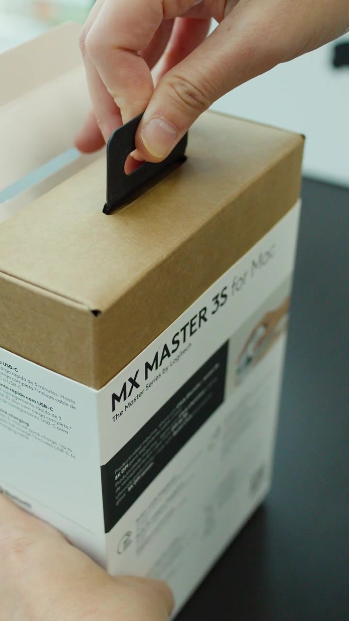 Hands unbox wireless mouse in bright, modern office using close-up shots and natural lighting
