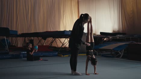 young gymnast training with a coach