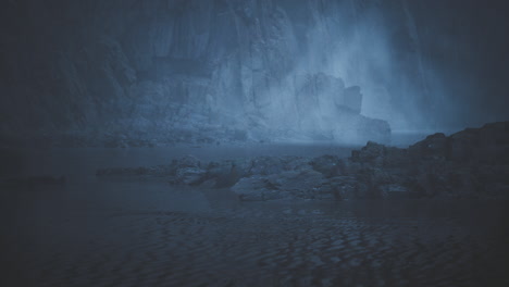 mysterious blue landscape with fog covering the rocky terrain at dusk