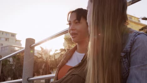 side view of a caucasian and a mixed race girl talking