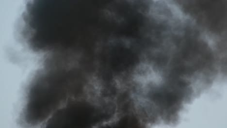 a large cloud of billowing black smoke