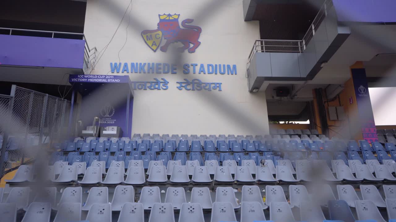 empty chairs in wankhede stadium and slowly reveal wankhede stadium logo board in closeup view in mumbai