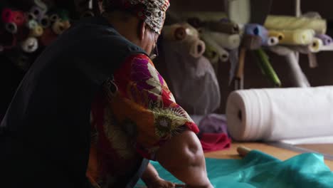 mixed race woman working at a hat factory