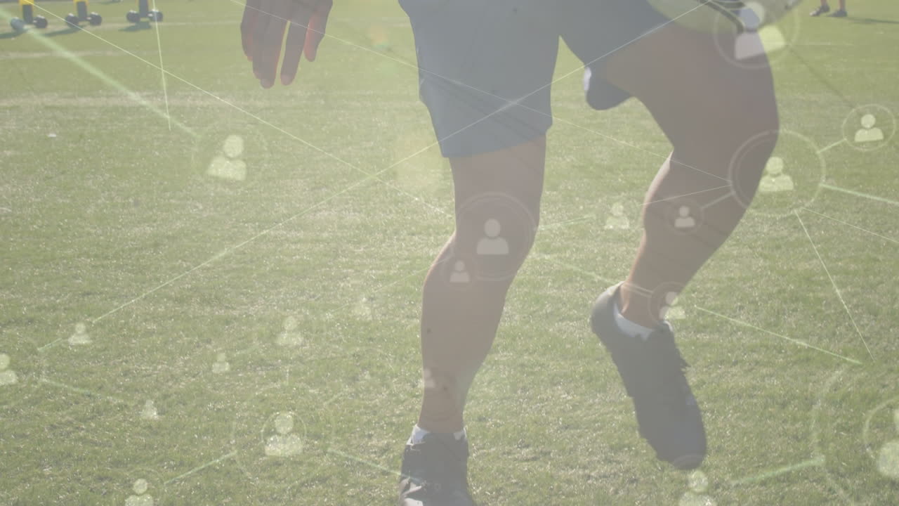 Animation of data processing over caucasian male soccer player kicking ball