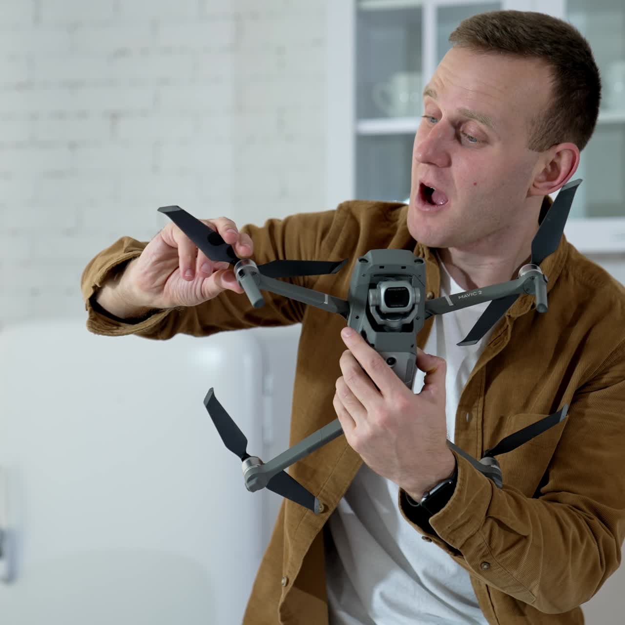 Man holding footage equipment. Young man holding drone for shooting video