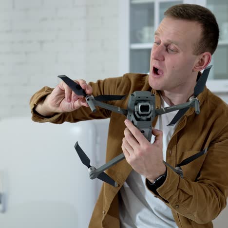 man holding footage equipment. young man holding drone for shooting video