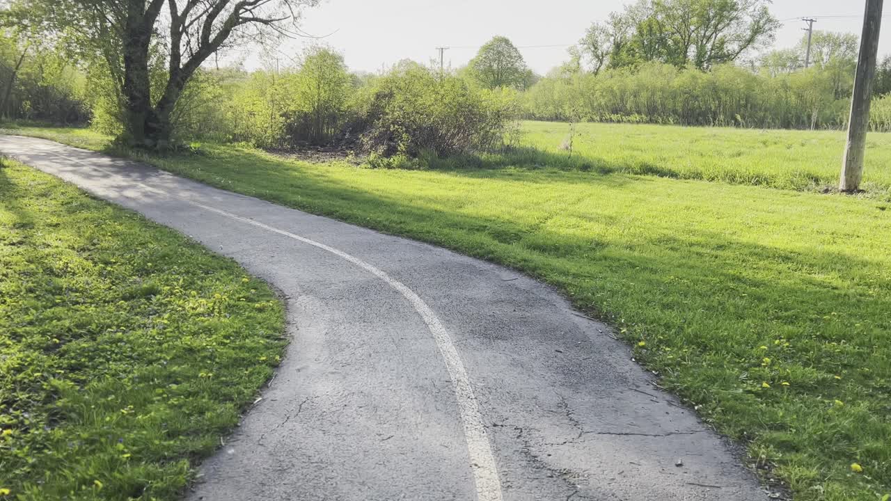 Rolling across a bike trail bridge in the summer