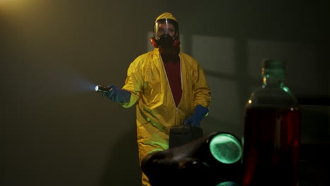 hazmat suit wearing man explores a dark room