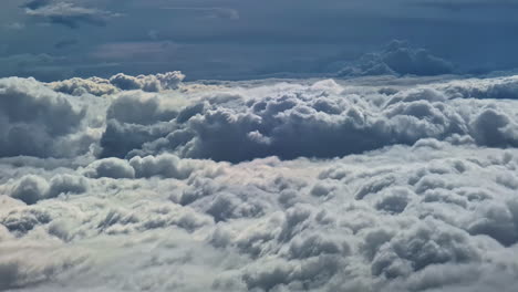 view of never ending cloud bed from airplane window during daytime
