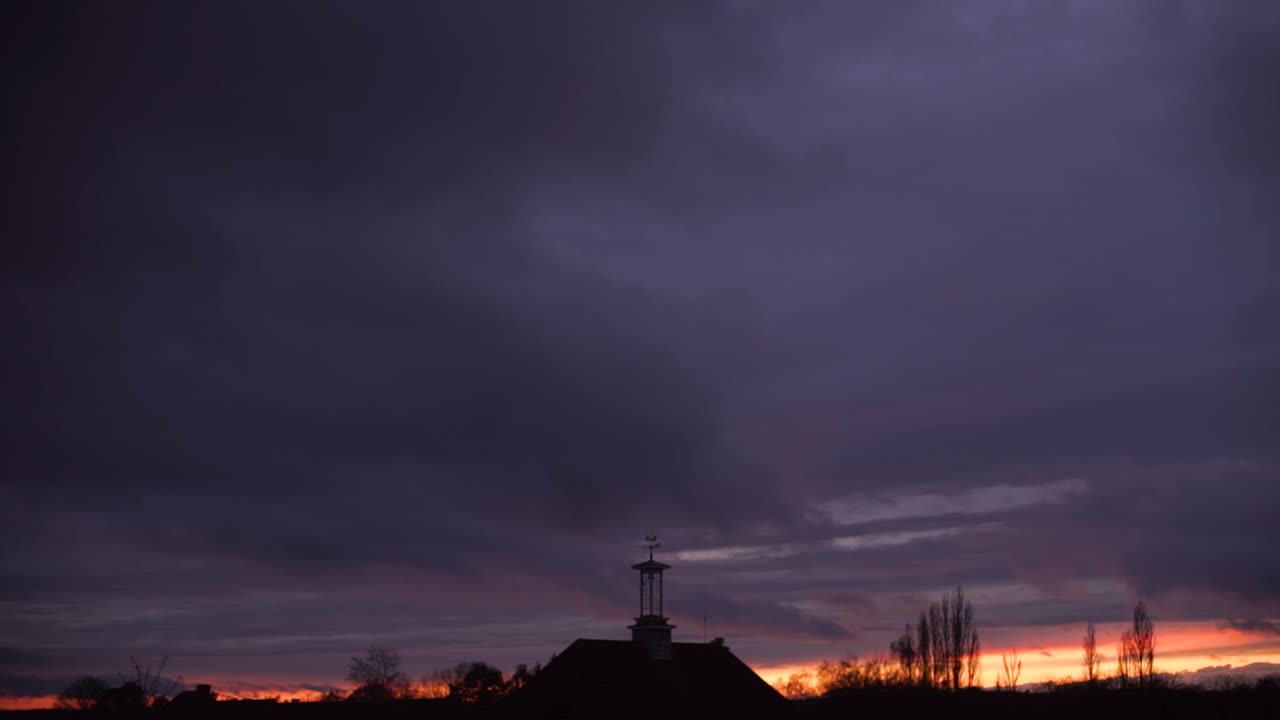 cumulonimbus cloud forming at sunset time lapse silhouette clock tower central