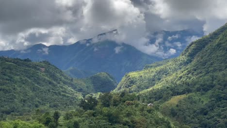 panorama of fluffy clouds over green mountains, valleys and villages in meghalaya, india