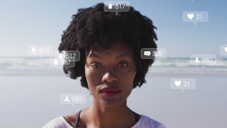 Animation-of-social-media-data-processing-over-african-american-woman-on-beach