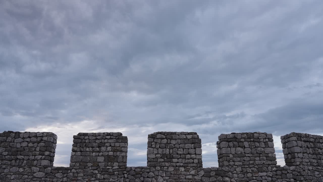 Old fortification wall of Rozafa Castle during the day with grey sky near Shkoder, northwestern Albania, wide shot
