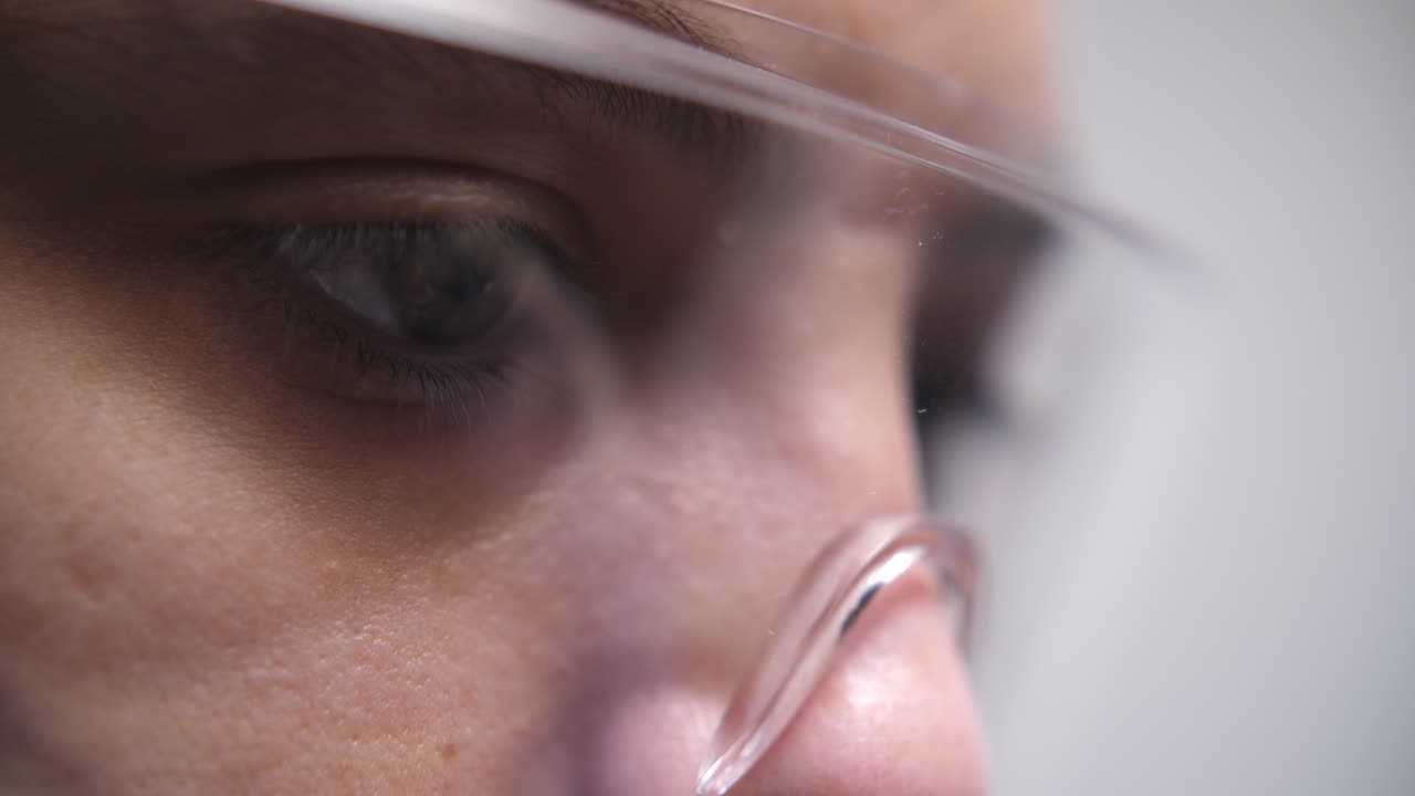 Close-up of Person's Eyes Focused Through Clear Safety Glasses