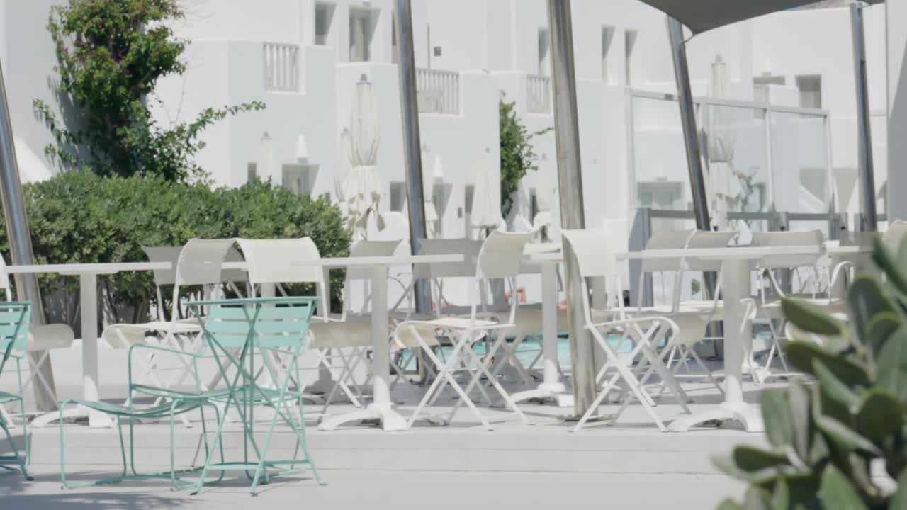 View of Santorini beach resort outdoor lounge behind cactus in Santorini, Greece