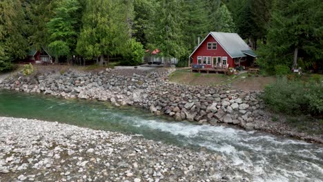 aerial view of a quaint red cabin overlooking the skykomish river in baring, washington