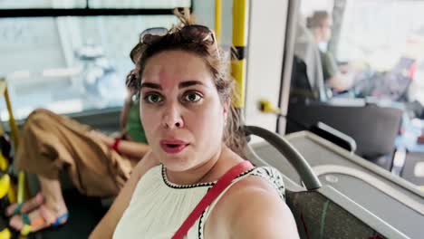 tourist vlogger expressing surprise while riding public bus in athens