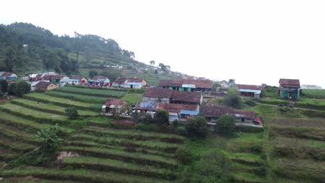 Cinematic-drone-shot-of-the-terrace-farming-village-of-Kukkal,-Kodaikanal,-Tamil-Nadu,-India