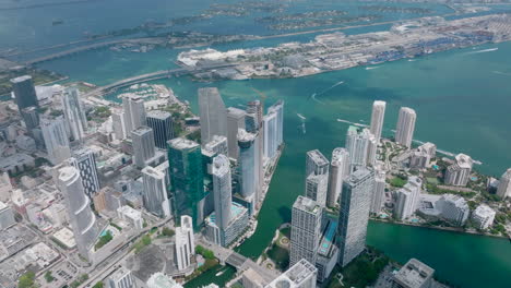 Aerial-panoramic-shot-of-downtown-skyscrapers-at-Miami-river-estuary.-Modern-business-town-district.-Miami,-USA