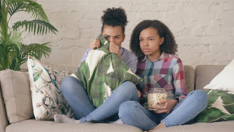 two girls watching a movie together
