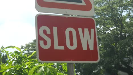 slow sign in a empty road ,