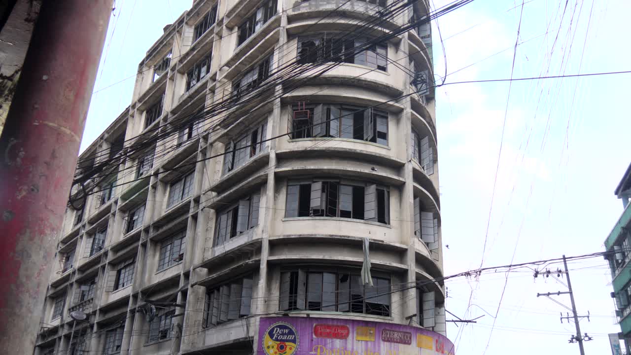 Old And Abandoned Building On Colon Street During Daytime In Cebu City, Philippines. tilt-up, panning shot
