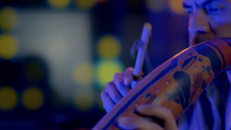 close shot of musician playing andean wire, from andes of peru and bolivia