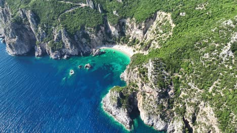 giali beach on corfu island with turquoise waters and rugged cliffs, sunny day, aerial view