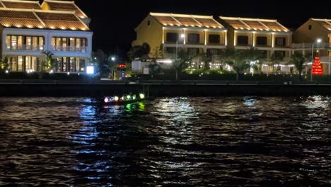 Hoi-An-Vietnam-Laternenboot-Kreuzfahrt-Entlang-Des-Thu-Bon-Flusses-Mit-Einem-Hoi-Hotels-Hinter