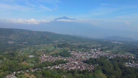 4k aerial footage capturing a picturesque rural landscape with vast greenery and a breathtaking mountain view. perfect for travel, nature, and documentary use
