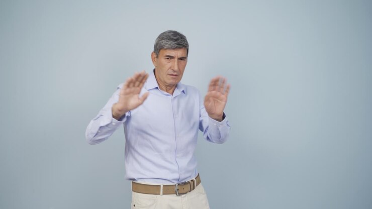 Fear reaction of old man looking at camera. Coward old man.